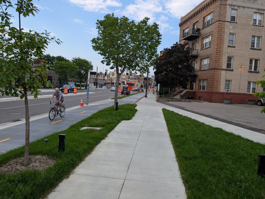 Older white man biking in Hennepin Avenue South bike lane